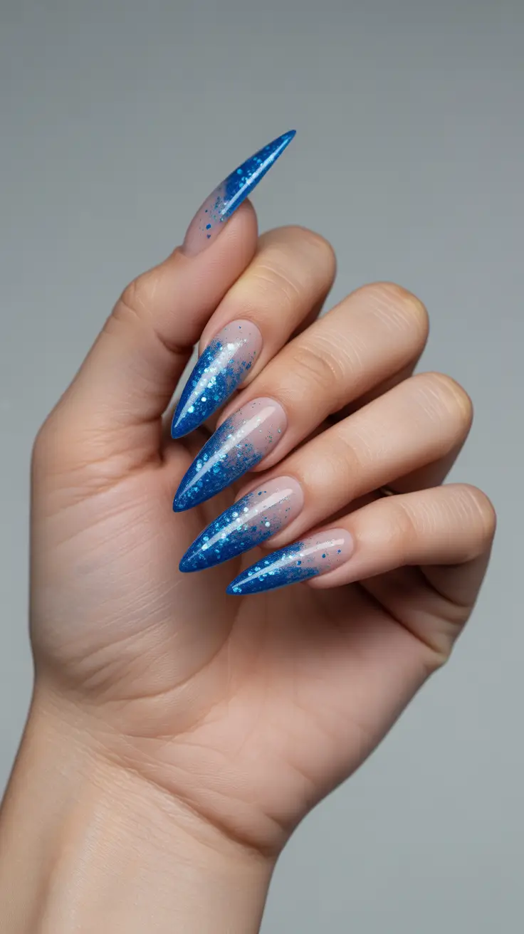 stiletto nails 2026 Blue Glitter Fade Stiletto Nails with Sharp French Tips